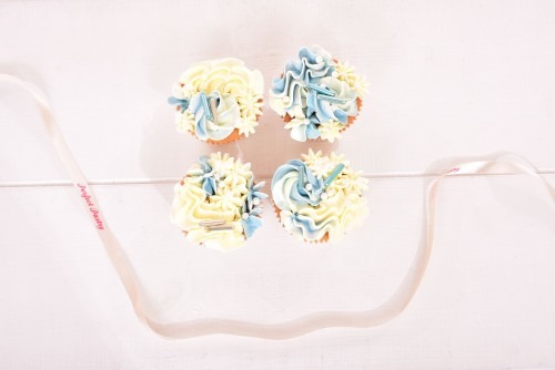 Baby shower cupcakes jongen blauw-en-witte-botercreme-cupcakes-met-blauw-decoraties-baby-shower-jongen